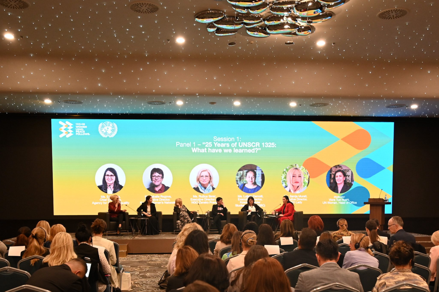 people sitting on a panel for the 25th anniversary of wps